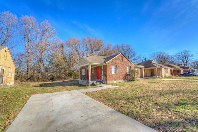 bungalow with a front lawn and brick siding