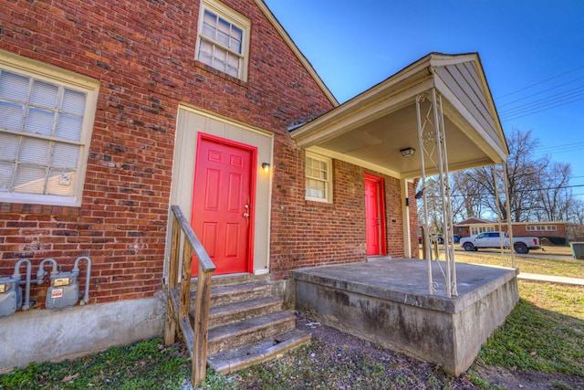 doorway to property with brick siding