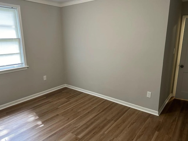 spare room featuring dark wood finished floors and baseboards