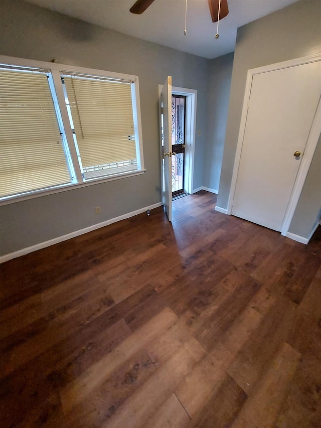 interior space featuring wood finished floors, a ceiling fan, and baseboards