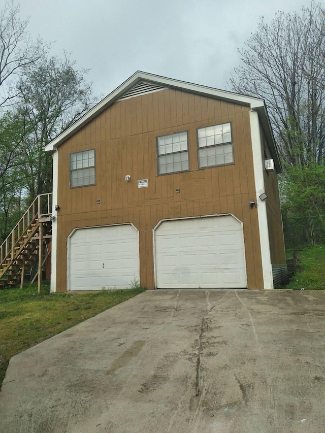 garage featuring concrete driveway