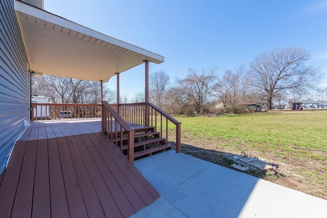 wooden terrace with a lawn and a patio