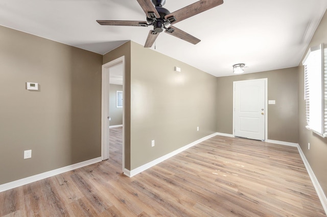 empty room with light wood-type flooring, ceiling fan, and baseboards