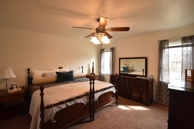 carpeted bedroom featuring multiple windows and a ceiling fan