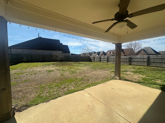 view of yard with a patio, a fenced backyard, and a ceiling fan