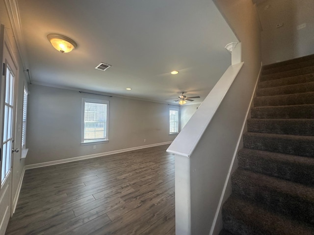 staircase featuring baseboards, visible vents, wood finished floors, crown molding, and recessed lighting