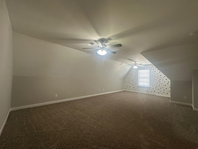 additional living space featuring ceiling fan, carpet, baseboards, and vaulted ceiling