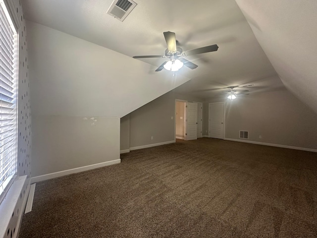 bonus room featuring vaulted ceiling, carpet flooring, visible vents, and baseboards