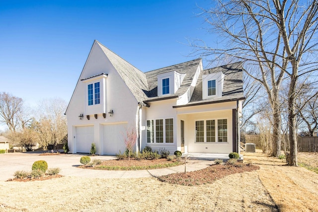 view of front facade with stucco siding, an attached garage, central AC, fence, and driveway