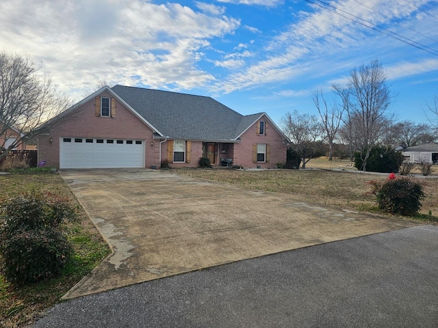 view of front of house with a garage, a front lawn, concrete driveway, and brick siding