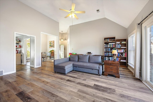 living area with visible vents, ceiling fan, and wood finished floors