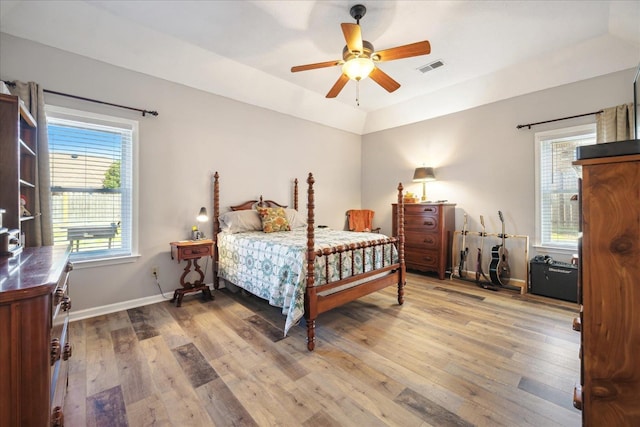 bedroom with wood-type flooring, visible vents, and baseboards