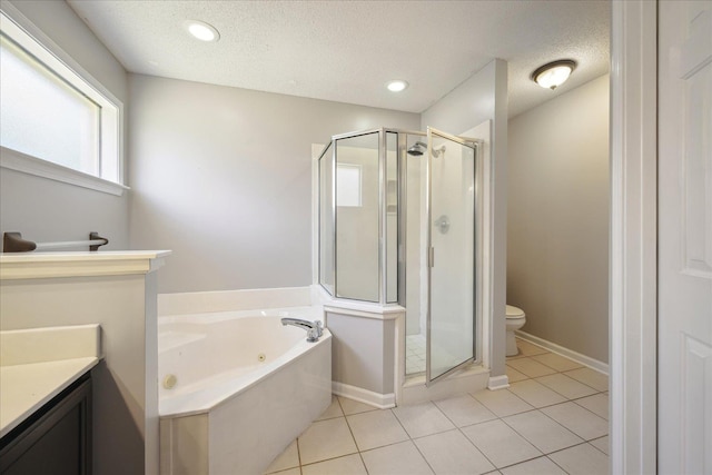 bathroom with a textured ceiling, vanity, a shower stall, tile patterned floors, and a whirlpool tub