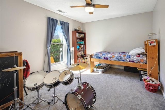 bedroom featuring a textured ceiling, carpet floors, visible vents, and a ceiling fan