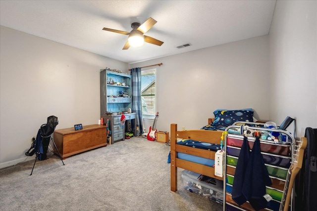 bedroom with carpet, visible vents, and ceiling fan