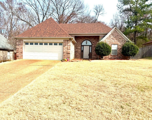 single story home with a garage, concrete driveway, brick siding, and a shingled roof