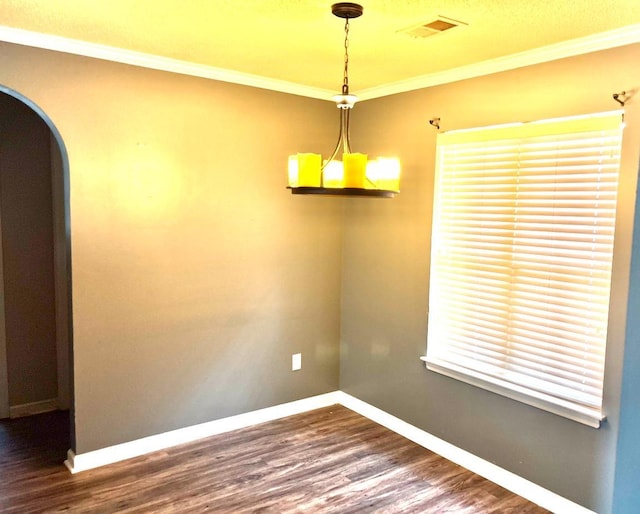 unfurnished room featuring arched walkways, baseboards, dark wood-style floors, and crown molding