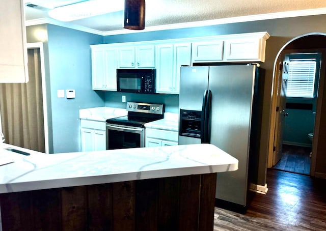 kitchen with ornamental molding, appliances with stainless steel finishes, dark wood-type flooring, and white cabinets