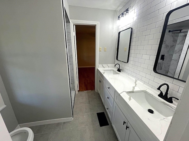 full bath with baseboards, a sink, and decorative backsplash