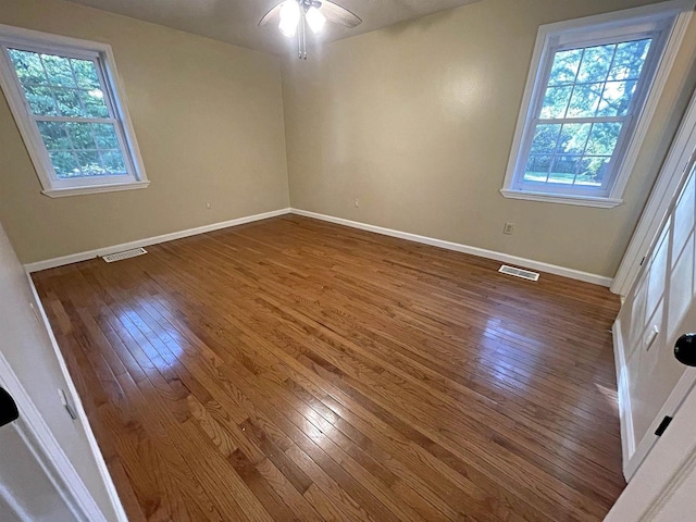 unfurnished bedroom with a ceiling fan, baseboards, visible vents, and hardwood / wood-style floors