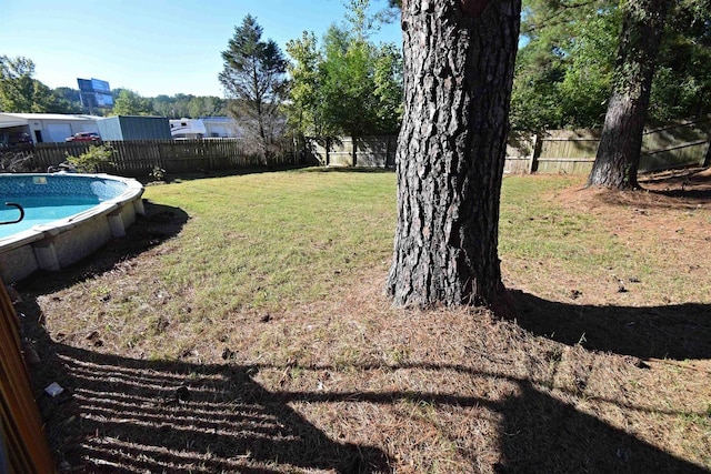 view of yard with a fenced in pool and a fenced backyard