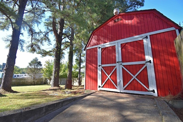 view of outdoor structure with an outbuilding and fence