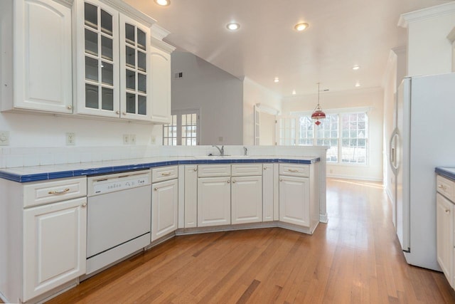 kitchen featuring a peninsula, white appliances, white cabinets, light wood-type flooring, and glass insert cabinets