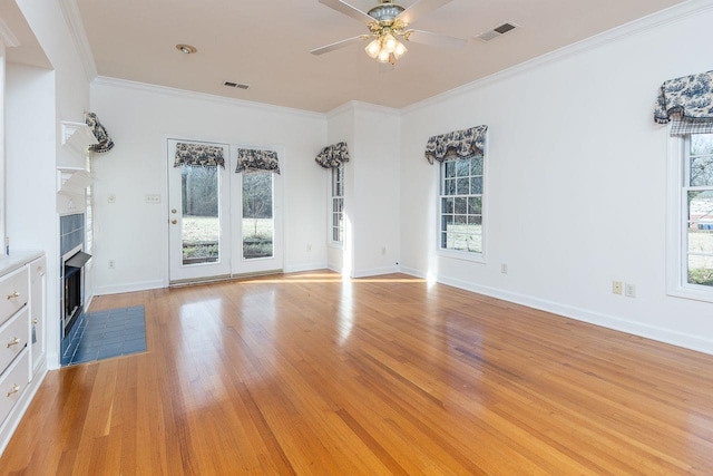 unfurnished living room with light wood finished floors, a ceiling fan, visible vents, and crown molding