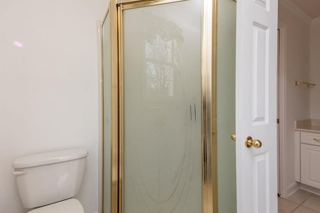 full bath featuring a stall shower, toilet, ornamental molding, tile patterned floors, and vanity