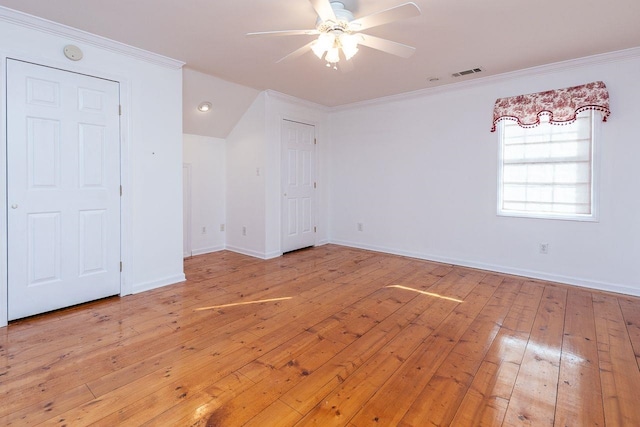 unfurnished bedroom with crown molding, visible vents, light wood-style floors, ceiling fan, and baseboards