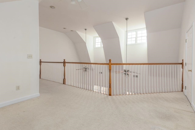 carpeted empty room with ceiling fan and baseboards