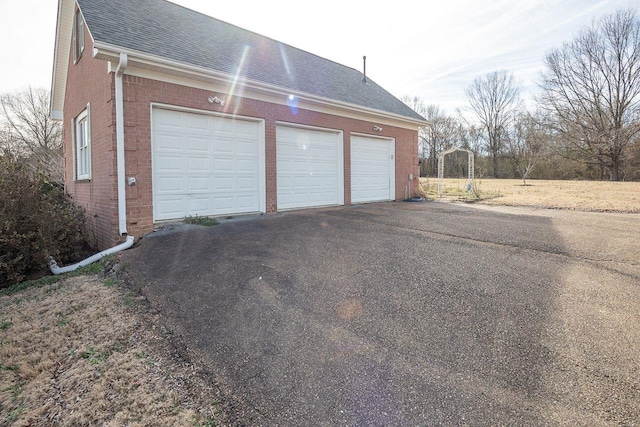 garage featuring aphalt driveway