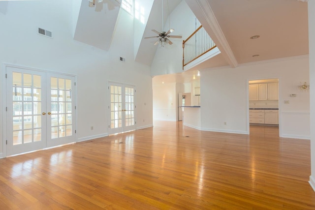 unfurnished living room featuring french doors, visible vents, ceiling fan, and light wood finished floors