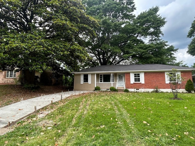 single story home featuring a porch, crawl space, a front yard, and brick siding