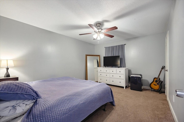 bedroom with light colored carpet, ceiling fan, a textured ceiling, and baseboards