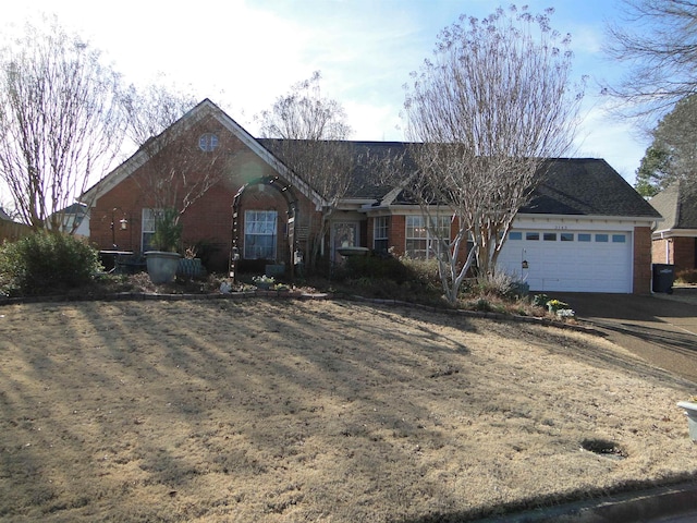 single story home featuring brick siding and an attached garage