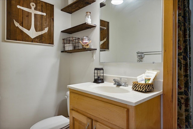 bathroom with vanity and toilet