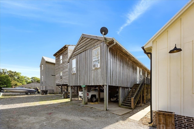 exterior space with stairs and a carport