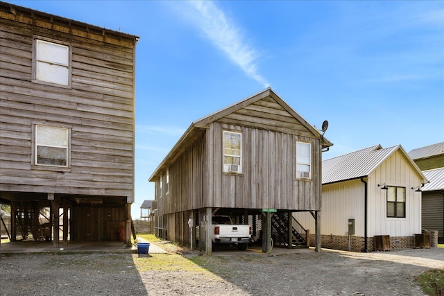 view of front of property with a carport, metal roof, and driveway