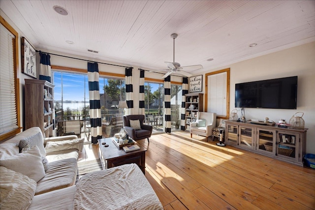 living room featuring visible vents, hardwood / wood-style flooring, wooden ceiling, and a wealth of natural light