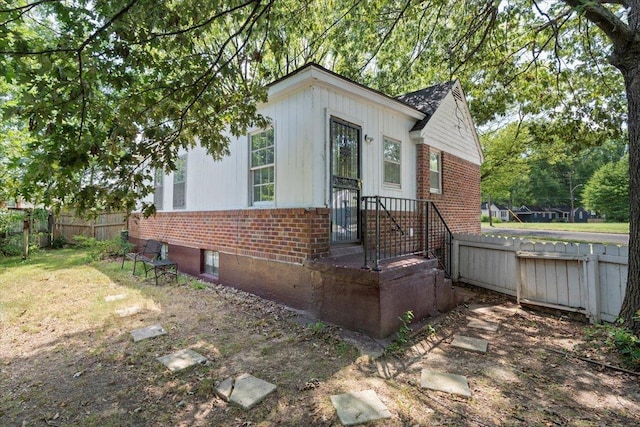 view of front of home with fence and brick siding