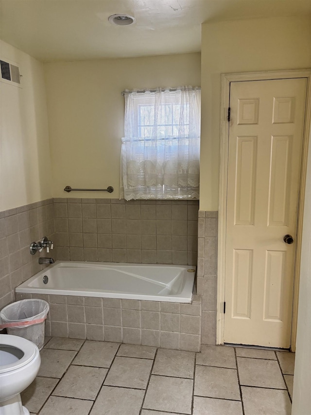 full bathroom with toilet, a garden tub, visible vents, and tile patterned floors