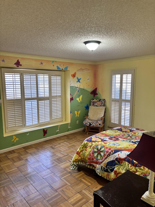 bedroom with ornamental molding, a textured ceiling, and baseboards