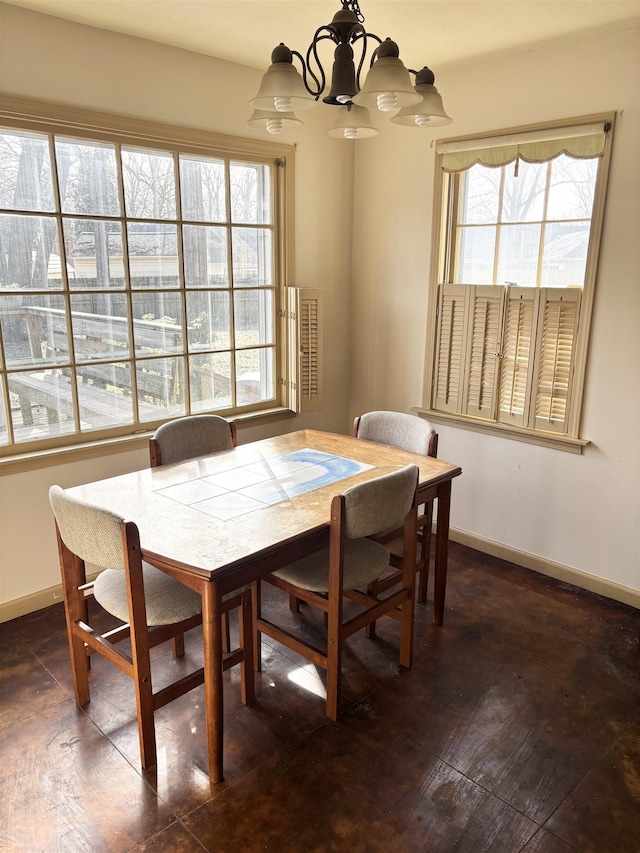 dining room featuring a notable chandelier, wood-type flooring, and baseboards