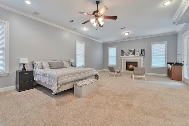 bedroom with light colored carpet, visible vents, baseboards, and a tile fireplace