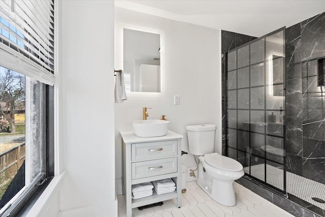 bathroom with a stall shower, tile patterned flooring, vanity, and toilet