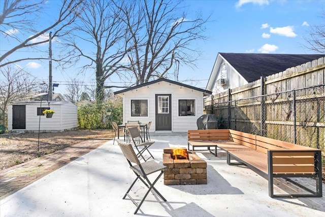 view of patio / terrace with an outdoor living space with a fire pit, an outbuilding, a grill, fence, and outdoor dining space