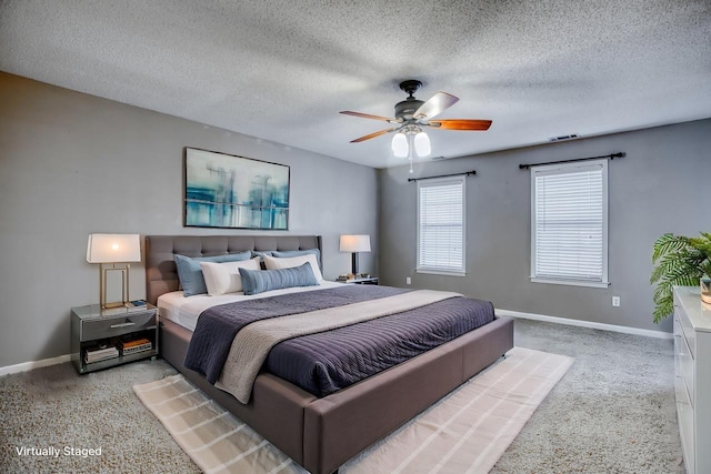 bedroom with visible vents, ceiling fan, a textured ceiling, and baseboards