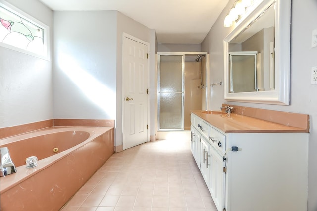 bathroom featuring a jetted tub, a stall shower, and vanity