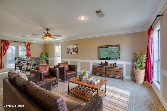 living area featuring visible vents, light colored carpet, ceiling fan, crown molding, and recessed lighting